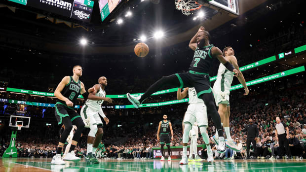 Jaylen Brown follows through after dunk vs. the Bucks